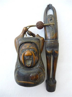 Lot 168 - A Japanese Carved and Stained Wood Kizerasutsu, circa 1880, the pipe holder as a tall and...