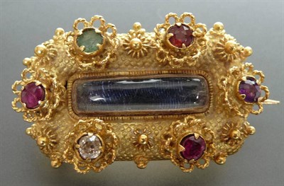 Lot 200 - A 'Regard' Brooch, the oblong beaded brooch with a central locket panel is bordered by ruby,...