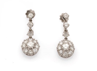 Lot 204 - A Pair of Diamond Drop Earrings, a round brilliant cut diamond cluster suspends from three...