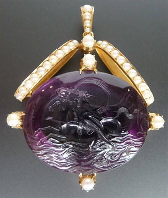 Lot 213 - An Amethyst and Seed Pearl Pendant, the carved amethyst depicting a figure on horseback, over waves