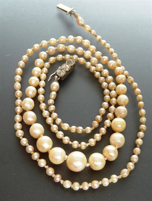 Lot 214 - A Pearl Necklace, the slightly off-round graduated pearls on a knotted strand, to a white stone set