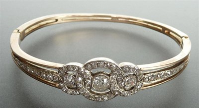 Lot 215 - A Victorian Diamond Set Bangle, three diamond set interlocking circles each surround a diamond,...