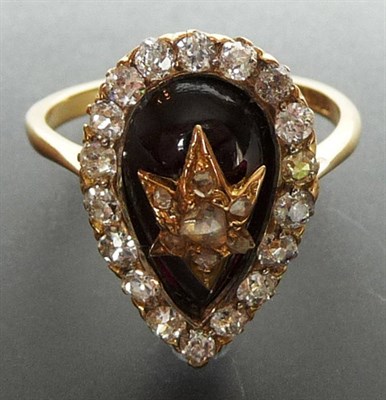 Lot 216 - A Pear Shaped Garnet and Diamond Ring, the pear shaped garnet cabochon with a diamond star...