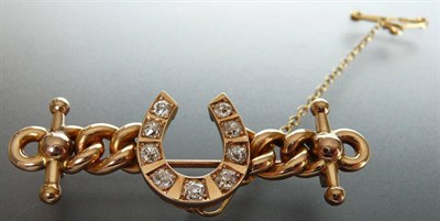 Lot 218 - A 9 Carat Gold Diamond Set Horseshoe Brooch, nine graduated old cut diamonds are claw set into...