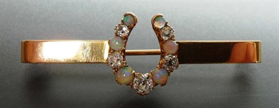 Lot 236 - A Victorian Opal and Diamond Horseshoe Bar Brooch, five graduated old cut diamonds alternate...