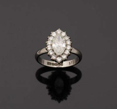 Lot 244 - An 18 Carat White Gold Diamond Cluster Ring, a marquise cut diamond sits above a row of round...