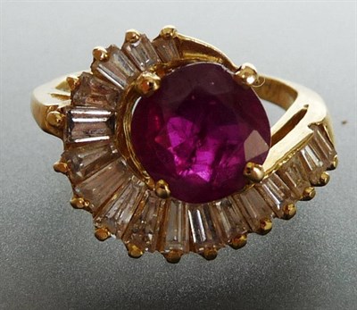 Lot 255 - A Ruby and Diamond Cluster Ring, the round brilliant cut ruby bordered by graduated tapered...