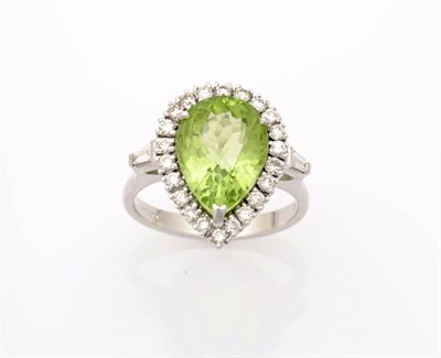 Lot 266 - A 14 Carat White Gold Peridot and Diamond Cluster Ring, the pear cut peridot held in a three...