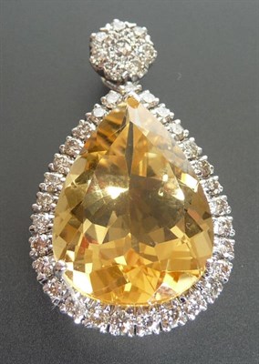 Lot 277 - An 18 Carat White Gold Citrine and Diamond Pendant, the pear cut citrine sits within a border...