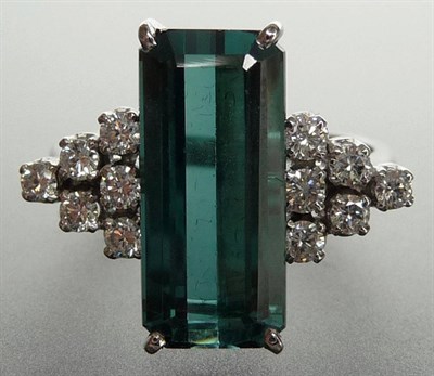 Lot 279 - A Blue-Green Tourmaline and Diamond Cluster Ring, the emerald cut tourmaline in a white four...