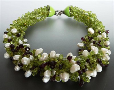 Lot 282 - A Peridot, Garnet and Cultured Pearl Torsade, rows of faceted peridot and garnet with irregular...