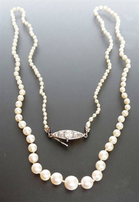 Lot 288 - A Pearl Necklace, one hundred and forty-seven graduated knotted pearls are strung to a diamond...