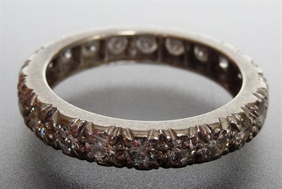 Lot 292 - A Diamond Eternity Ring, round brilliant cut diamonds held in claw carved settings on a plain...