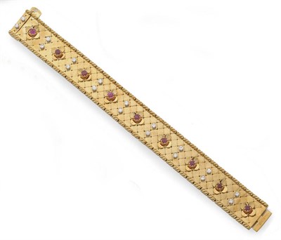 Lot 298 - A Diamond and Ruby Set Bracelet, polished yellow tile links sit between two rows of rope edge...