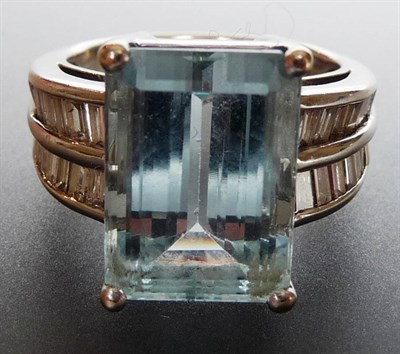 Lot 307 - An Aquamarine and Diamond Art Deco Style Ring, the central baguette cut aquamarine held in a...