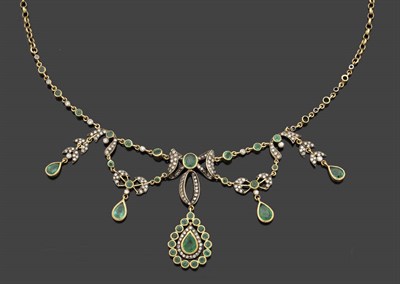 Lot 314 - A 9 Carat Gold Emerald and Diamond Necklace, a central oval emerald bordered by diamonds in a...