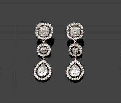 Lot 321 - A Pair of Diamond Drop Earrings, two graduated cushion cut diamonds and a pear cut diamond sit...