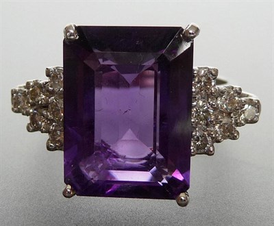 Lot 324 - A 14 Carat White Gold Amethyst and Diamond Ring, a baguette cut amethyst in a white four claw...