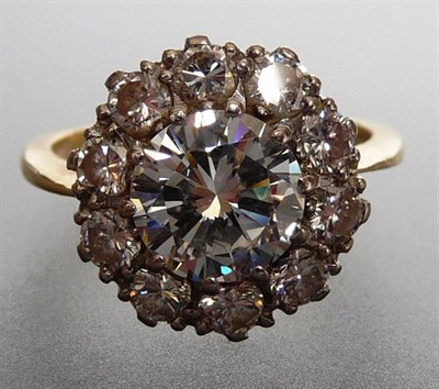 Lot 328 - A Diamond Cluster Ring, a central round brilliant cut diamond bordered by a row of smaller...