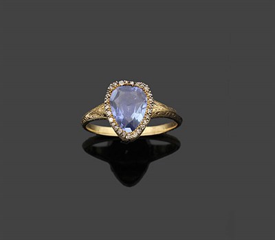 Lot 352 - A Sapphire and Diamond Cluster Ring, the pear cut sapphire within a border of rose and...