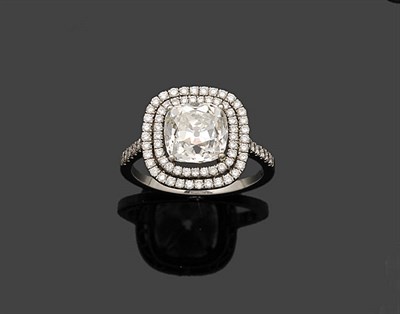 Lot 355 - A Diamond Cluster Ring, the cushion cut diamond held in a white claw setting sits above a...