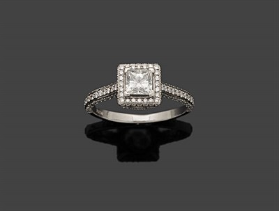 Lot 359 - A Diamond Cluster Ring, the princess cut diamond in a four claw white setting sits above a...