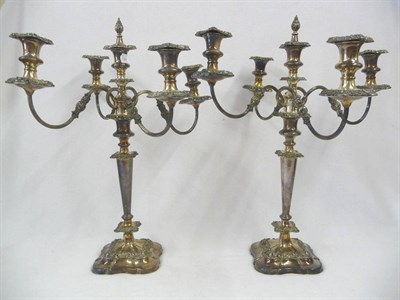 Lot 384 - A Pair of Electroplate Five-Light Candelabra, shaped square base rising ot a flared stem with a...