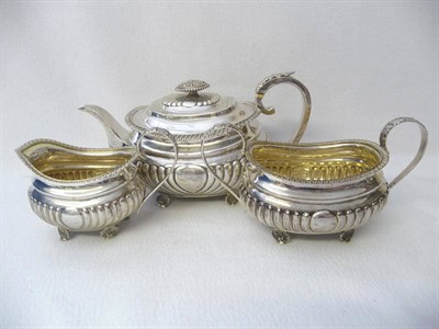 Lot 464 - A George III Three Piece Teaset, Hougham, Royes & Dix, London 1817, of oblong part lobed form...