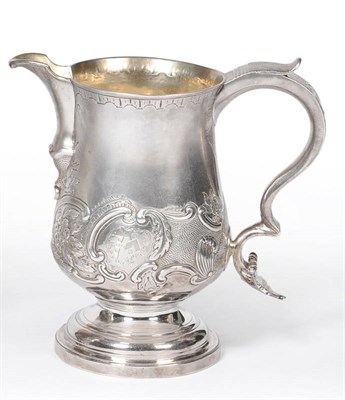 Lot 465 - A George III Jug, maker's mark IA, London 1774, the spreading foot rising to a part foliate...