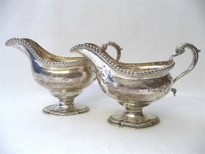 Lot 478 - A Pair of George III Sauceboats, London 1772, the shaped quatrefoil gadrooned pedestal foot...