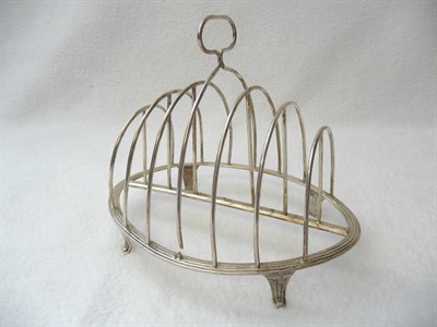 Lot 482 - A George III Toastrack, William Plummer, London 1788, the reeded oval base raised on four...