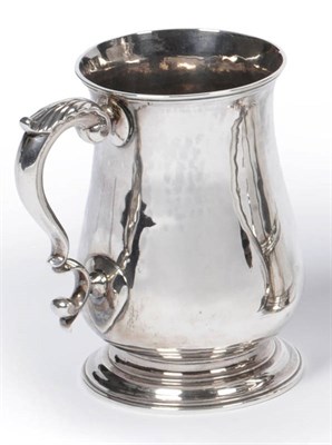 Lot 484 - A George III Mug, Thomas Moore II, London 1760, of plain baluster form with leaf capped scroll...