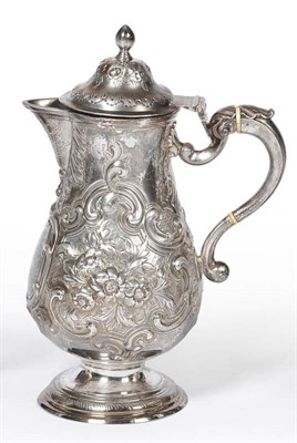 Lot 495 - A George III Irish Jug, maker's mark IW, Dublin, circa 1765, the spreading foot rising to a...