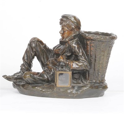 Lot 555 - J Cardona (French): A Bronze Figural Lamp, circa 1900, as a young boy with a large basket on...