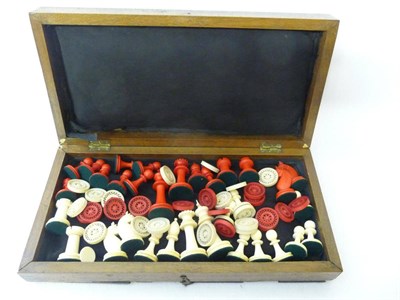 Lot 593 - A Carved and Stained Bone Chess Set, circa 1900, one set stained red, the kings 8.2cm high,...