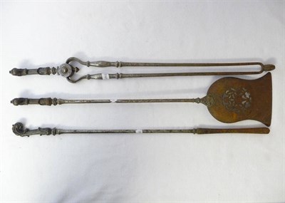 Lot 645 - A Set of Three Steel Fire Irons, early 19th century, with cast iron rococo scroll form handles, the