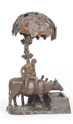 Lot 647 - A Continental Bronzed Spelter Figural Table Lamp, circa 1910, modelled as a cow herder seated...