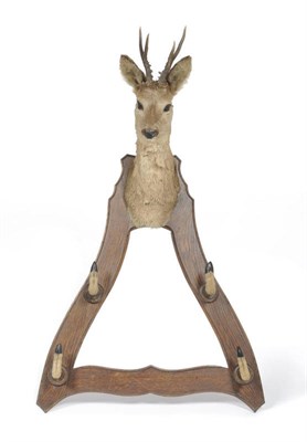 Lot 691 - A Dutch Oak and Roe Deer Head Mounted Coat Rack, circa 1910, the serpentine sided triangular...