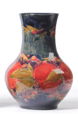 Lot 1031 - A William Moorcroft "Pomegranate" Vase, on a blue ground, painted green signature, impressed...