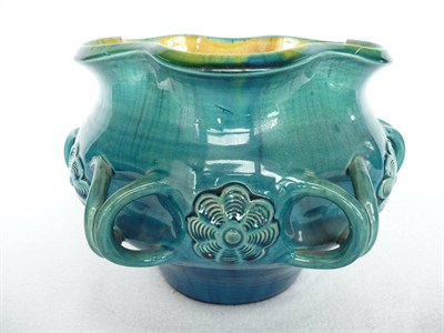 Lot 1046 - A Linthorpe Pottery Jardiniere, shape No.535, with twin loop handles and flower head...