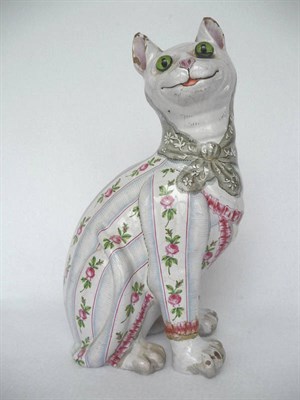 Lot 1056 - A Continental Faience Model of a Seated Cat, in the manner of Galle, wearing a jacket painted...