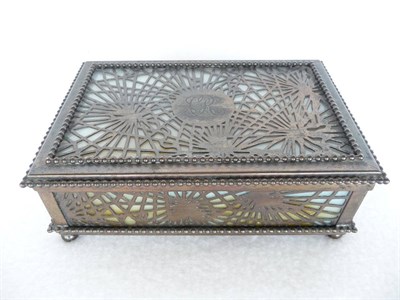 Lot 1070 - A Tiffany Studios Bronze Hinged Box, pine needles pattern over white, orange/yellow glass,...