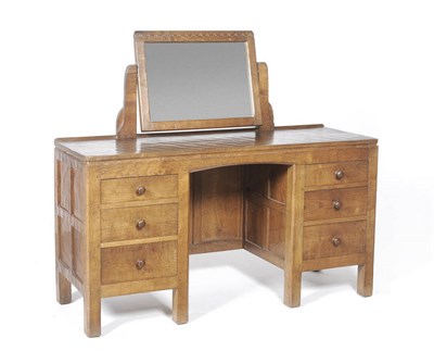 Lot 1082 - A Robert "Mouseman" Thompson Panelled Oak Dressing Table, with swing mirror, above three graduating