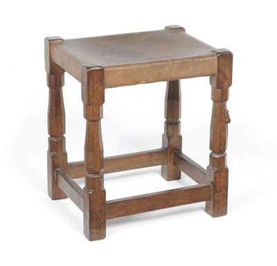 Lot 1083 - A Robert "Mouseman" Thompson Oak Dressing Table Stool, on four octagonal legs joined together...