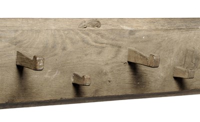 Lot 1088 - A Robert "Mouseman" Thompson Oak Hat Rail, with twenty-one pegs, with two carved mice...