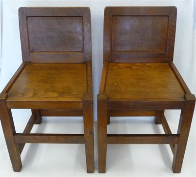 Lot 1091 - A Pair of Robert "Mouseman" Thompson Oak Low Panel Back Chairs, with solid seats, on square section