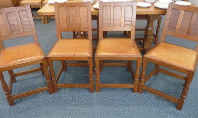 Lot 1110 - A Set of Eight Colin "Beaverman" Almack Oak Panel Back Dining Chairs, with hide seats on...