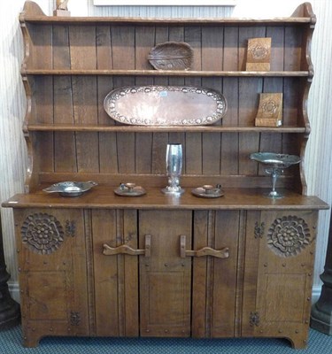 Lot 1123 - An Arts & Crafts Oak Dresser, by Jack Grimble of Cromer, the plate rack above two cupboard...