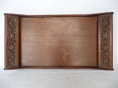 Lot 1127 - An Arts & Crafts Oak Tray, by Arthur W Simpson, the handles with carved floral decoration, with...