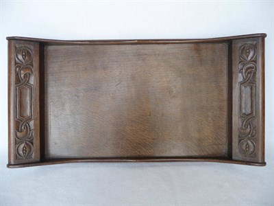 Lot 1128 - An Arts & Crafts Oak Tray, by Arthur W Simpson, the handles with carved decoration, unmarked,...